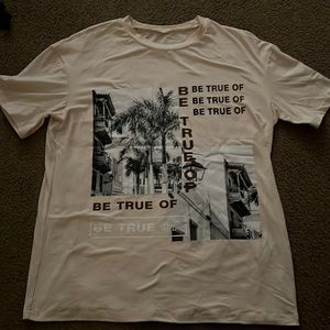 Large Graphic Tee. Color: Cream, White, Brown